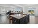 Bright kitchen with a granite island and stainless steel appliances open to the living area at 135 Carlton Ln, Franklinton, NC 27525