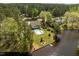 Beautiful lakefront property featuring a home with a balcony, a pool with a fence, and a dock at 1422 Gormly Cir, Sanford, NC 27330