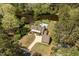 Aerial view of waterfront home with a private pool, well-maintained landscaping, and an impressive driveway and detached garage at 1422 Gormly Cir, Sanford, NC 27330