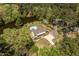 Aerial view of a lakefront home with a pool and lush landscaping, with mature trees and a winding driveway at 1422 Gormly Cir, Sanford, NC 27330