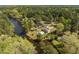 Overhead view of a beautiful house on a lake with trees, manicured landscaping, and a pristine pool at 1422 Gormly Cir, Sanford, NC 27330