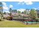 Stunning back exterior view showcasing a pool, patio and screened in porch overlooking a well-manicured lawn at 1422 Gormly Cir, Sanford, NC 27330