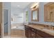 Bathroom with double vanity, jetted tub, tile flooring, and walk-in shower at 1422 Gormly Cir, Sanford, NC 27330