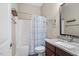 Well-lit bathroom features a shower-tub combination and granite vanity at 1422 Gormly Cir, Sanford, NC 27330