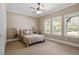 Sun-filled bedroom with carpeted floors and large windows at 1422 Gormly Cir, Sanford, NC 27330