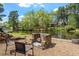 Outdoor fire pit area with chairs overlooking a lake and scenic green landscape at 1422 Gormly Cir, Sanford, NC 27330
