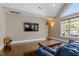 Cozy living room featuring hardwood floors, a large TV, and comfortable seating area at 1422 Gormly Cir, Sanford, NC 27330