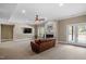 Spacious living room featuring a fireplace, ceiling fan, and doors leading to the exterior at 1422 Gormly Cir, Sanford, NC 27330