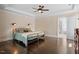 Bedroom featuring hardwood floors, tray ceiling, and ensuite bathroom at 1422 Gormly Cir, Sanford, NC 27330