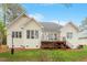 Rear exterior of home with back deck, stairs and lush landscaping at 1537 Heritage Club Ave, Wake Forest, NC 27587