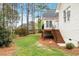 Backyard featuring a deck, stairs to the yard and mature trees at 1537 Heritage Club Ave, Wake Forest, NC 27587