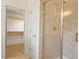 Walk-in shower featuring tile walls and floor with an open doorway to a walk-in closet at 1537 Heritage Club Ave, Wake Forest, NC 27587