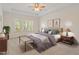 Calm bedroom features a decorative ceiling fan, plush carpeting, and a comfortable queen bed at 1537 Heritage Club Ave, Wake Forest, NC 27587