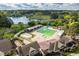 Aerial view of a large community pool with a slide and lounge area, surrounded by mature trees and a lake view at 1537 Heritage Club Ave, Wake Forest, NC 27587