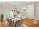 Bright dining area features wood floors, wainscoting, marble table, and ample natural light at 1537 Heritage Club Ave, Wake Forest, NC 27587