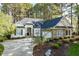 Charming one-story home with manicured landscaping, stone accents, and a paved driveway at 1537 Heritage Club Ave, Wake Forest, NC 27587