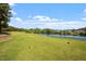Beautiful golf course view near a lush green with a pond in the distance on a sunny day at 1537 Heritage Club Ave, Wake Forest, NC 27587