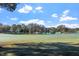 Picturesque golf course featuring a serene pond surrounded by trees, under a bright sky at 1537 Heritage Club Ave, Wake Forest, NC 27587