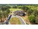 Aerial view of the clubhouse on the golf course featuring a scenic landscape, surrounded by mature trees and lush fairways at 1537 Heritage Club Ave, Wake Forest, NC 27587