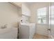 Laundry room featuring a washer, dryer, utility sink, and storage cabinets at 1537 Heritage Club Ave, Wake Forest, NC 27587