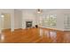 Cozy living room with hardwood floors, a fireplace, and large windows at 1537 Heritage Club Ave, Wake Forest, NC 27587