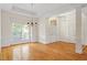 Large living room with elegant chandelier and hardwood floors at 1537 Heritage Club Ave, Wake Forest, NC 27587