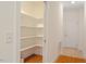 Large walk-in pantry with ample shelving space, and easy access to the entryway at 1537 Heritage Club Ave, Wake Forest, NC 27587