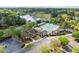 Aerial view of the pool and community amenities, with a lake, parking, and mature trees at 1537 Heritage Club Ave, Wake Forest, NC 27587