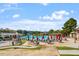 Inviting community pool area with lounge chairs, umbrellas and a water slide at 1537 Heritage Club Ave, Wake Forest, NC 27587