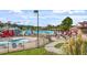 Inviting community pool area with lounge chairs, umbrellas and a water slide at 1537 Heritage Club Ave, Wake Forest, NC 27587