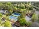 Aerial view showcasing two well-maintained tennis courts surrounded by lush greenery in a serene setting at 1537 Heritage Club Ave, Wake Forest, NC 27587