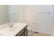 Well-lit bathroom featuring a dark wood vanity, a combination shower-tub, and modern fixtures at 157 Durants Neck Ln, Morrisville, NC 27560