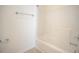 Bright bathroom featuring a white shower-tub combination with tile surround and modern fixtures at 157 Durants Neck Ln, Morrisville, NC 27560