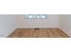 Bright bedroom with beautiful wood flooring and natural light from window at 157 Durants Neck Ln, Morrisville, NC 27560