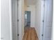 Hallway with wood flooring and neutral paint leads to additional rooms at 157 Durants Neck Ln, Morrisville, NC 27560