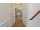 Hallway with hardwood floors, white trim, and doors at 157 Durants Neck Ln, Morrisville, NC 27560