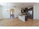 Open kitchen featuring an island, granite counters, stainless steel appliances, and hardwood floors at 157 Durants Neck Ln, Morrisville, NC 27560