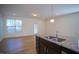 Open kitchen featuring an island, granite counters, stainless steel appliances, and hardwood floors at 157 Durants Neck Ln, Morrisville, NC 27560