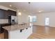 Open kitchen featuring an island, granite counters, stainless steel appliances, and a dining area at 157 Durants Neck Ln, Morrisville, NC 27560