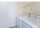 Functional laundry area featuring modern washer and dryer units with an overhead storage shelf at 157 Durants Neck Ln, Morrisville, NC 27560