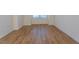 Bright room featuring wood-look flooring and a window with modern blinds, perfect for a home office at 157 Durants Neck Ln, Morrisville, NC 27560