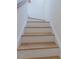 Clean stairway featuring wood treads and risers, offering a bright transition between floors at 157 Durants Neck Ln, Morrisville, NC 27560