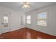 Bedroom with wood floors, white walls, two windows, and a ceiling fan at 1631 Sunset Ave, Henderson, NC 27536