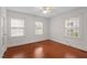 Spacious bedroom with hardwood floors, ample natural light from two windows, and plenty of room for personalization at 1631 Sunset Ave, Henderson, NC 27536