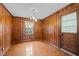 Traditional dining room showcases wood paneling, ample light, and original wood floors, creating a warm, inviting space at 1631 Sunset Ave, Henderson, NC 27536