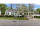 Charming one-story home with a quaint wooden fence and a covered carport for convenient parking at 1631 Sunset Ave, Henderson, NC 27536