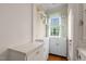 Bright eat-in kitchen with white cabinetry and natural light from a large window at 1631 Sunset Ave, Henderson, NC 27536