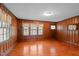 Spacious living room showcases wood paneling, ample natural light, and hardwood floors, exuding warmth and character at 1631 Sunset Ave, Henderson, NC 27536