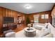 Cozy living room featuring wood paneling, a neutral sofa, and an open layout, perfect for relaxation at 1631 Sunset Ave, Henderson, NC 27536