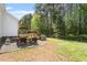 This backyard features a nice deck, table and barbecue at 1752 Cobblestone Dr, Creedmoor, NC 27522
